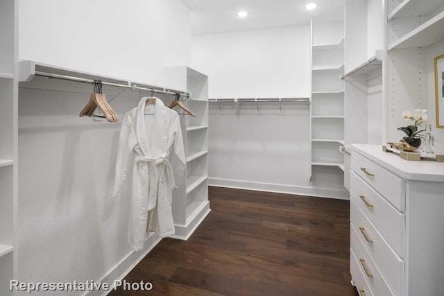 walk in closet with dark hardwood / wood-style flooring