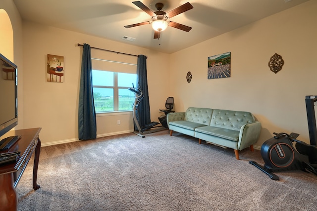 living area with carpet flooring and ceiling fan