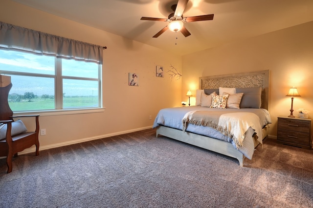 bedroom with ceiling fan and dark colored carpet