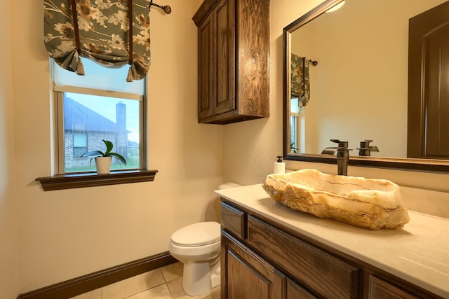 bathroom with toilet, tile patterned flooring, and vanity