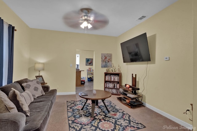 carpeted living room with ceiling fan