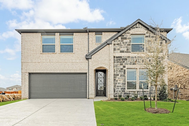 view of front facade with brick siding, concrete driveway, an attached garage, a front yard, and stone siding