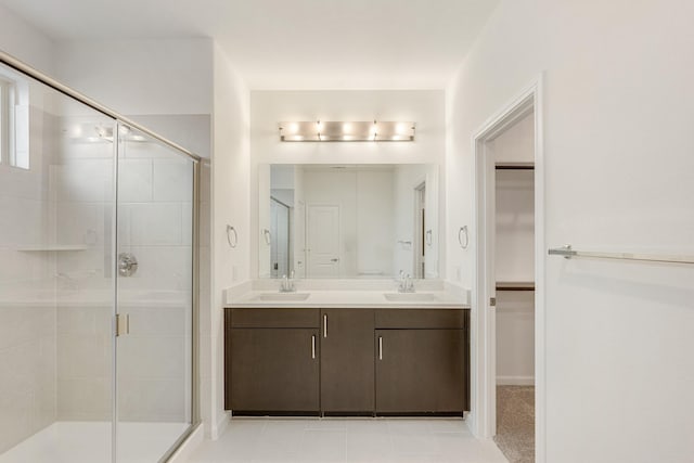 bathroom with a shower with door and vanity