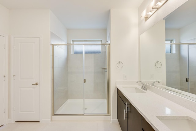 bathroom featuring walk in shower, tile patterned floors, and vanity