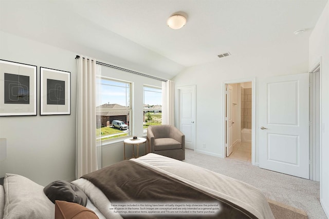 carpeted bedroom with lofted ceiling and ensuite bath