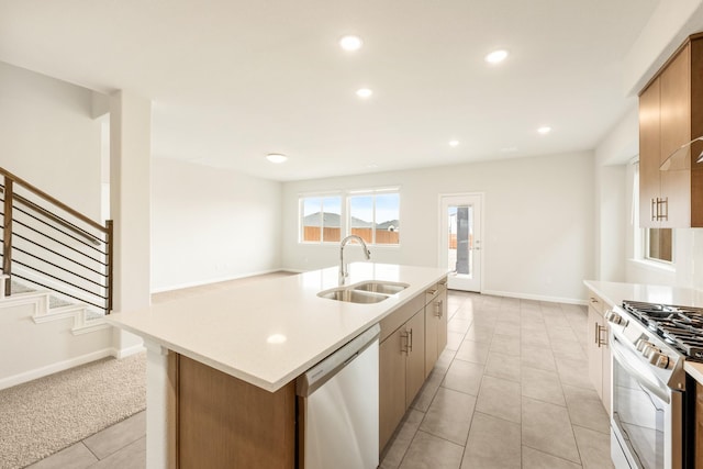 kitchen featuring appliances with stainless steel finishes, recessed lighting, light countertops, and a sink