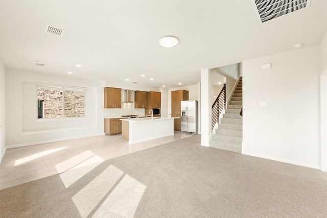 unfurnished living room featuring light carpet, stairway, visible vents, and recessed lighting