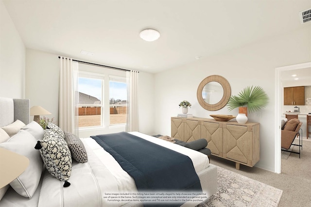 bedroom with visible vents and light colored carpet