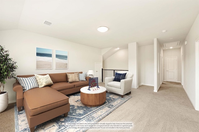 carpeted living area with visible vents, lofted ceiling, attic access, and baseboards