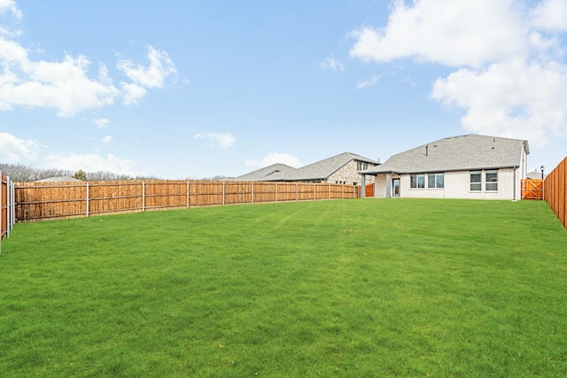 view of yard with a fenced backyard