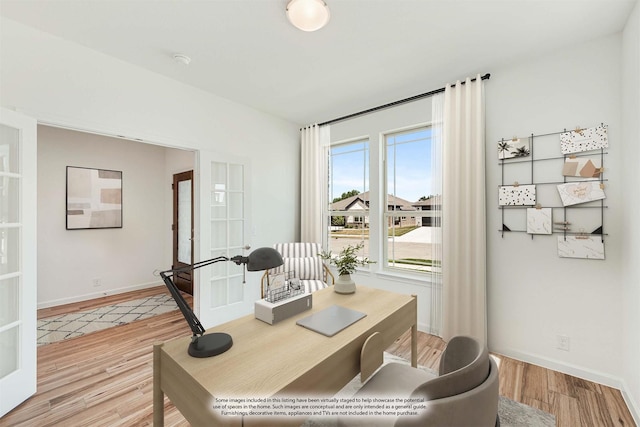 office area with light wood-type flooring and french doors