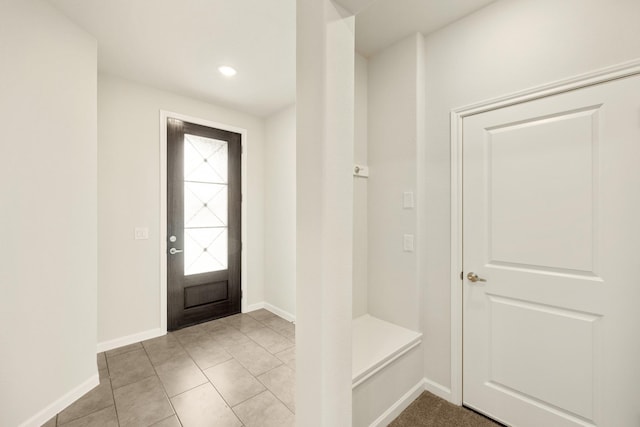 mudroom featuring light tile patterned floors and baseboards