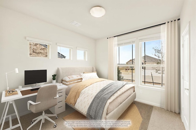 carpeted bedroom featuring multiple windows, visible vents, and baseboards