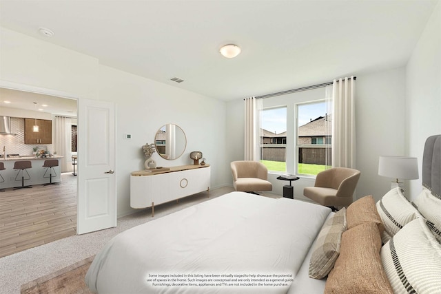 bedroom with sink and hardwood / wood-style floors