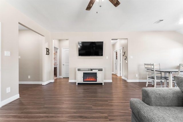 living room with lofted ceiling, dark hardwood / wood-style floors, and ceiling fan