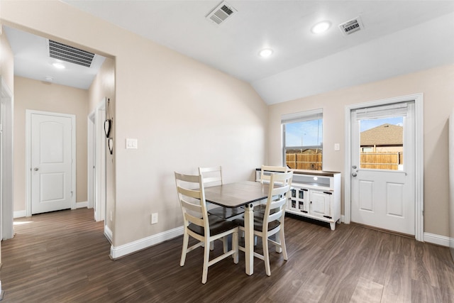 dining space with vaulted ceiling and dark hardwood / wood-style flooring