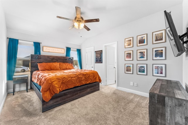 carpeted bedroom with ceiling fan and vaulted ceiling