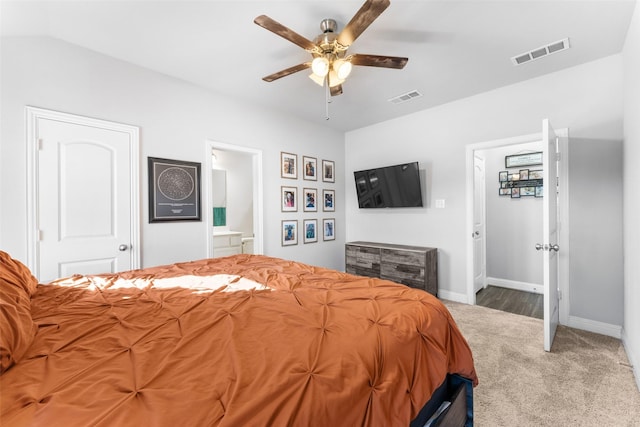 carpeted bedroom with ceiling fan and ensuite bathroom