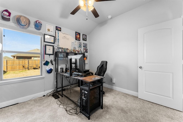 carpeted office space featuring vaulted ceiling and ceiling fan