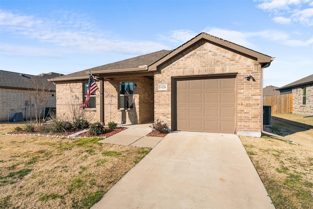 view of front of property with cooling unit, a garage, and a front lawn