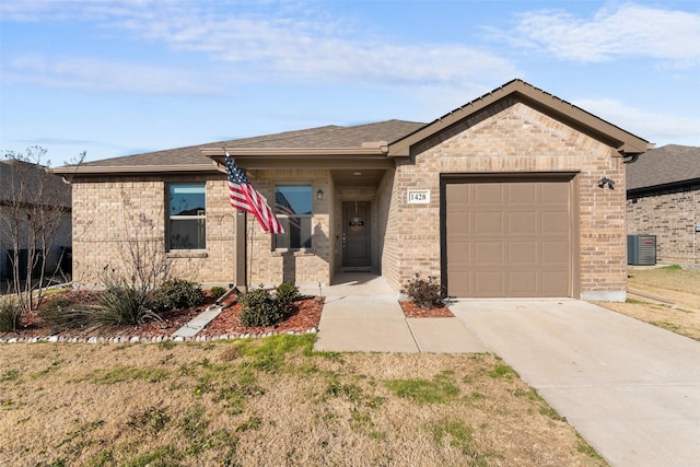 view of front of home featuring a garage and central air condition unit