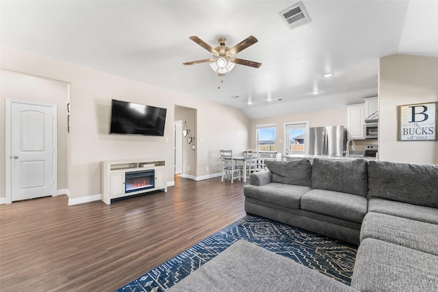 living room featuring sink, vaulted ceiling, ceiling fan, and dark hardwood / wood-style flooring