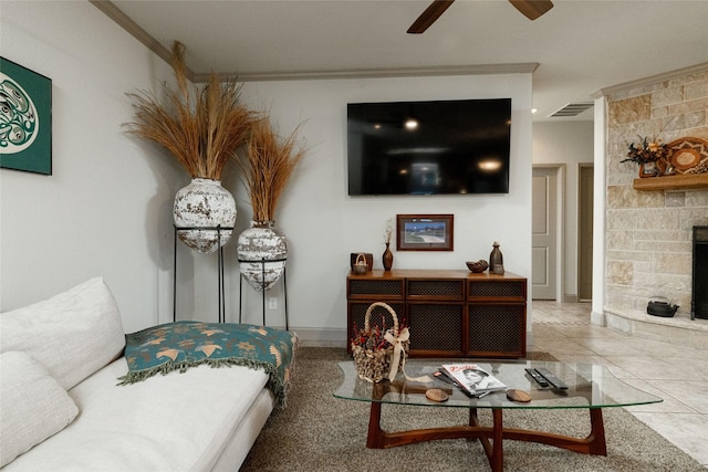 living room featuring ceiling fan, tile patterned flooring, and a fireplace