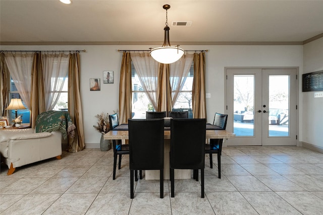 dining space with french doors, ornamental molding, and tile patterned flooring