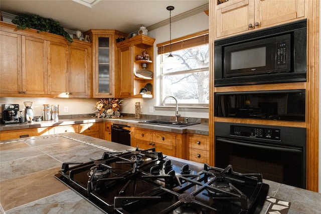 kitchen with black appliances, ornamental molding, pendant lighting, and sink