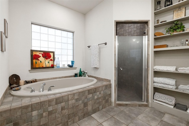 bathroom with separate shower and tub and tile patterned flooring