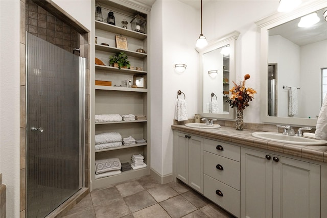 bathroom featuring a shower with door and vanity