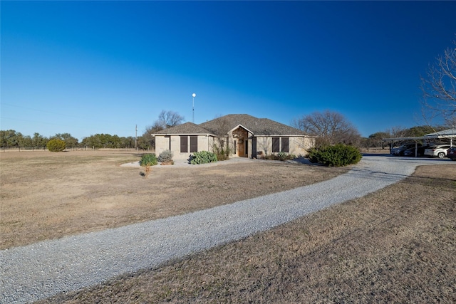 ranch-style house with a front lawn