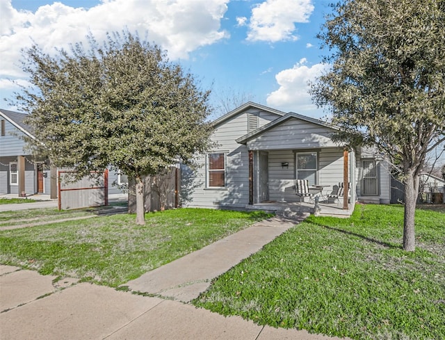 bungalow-style house with covered porch and a front yard