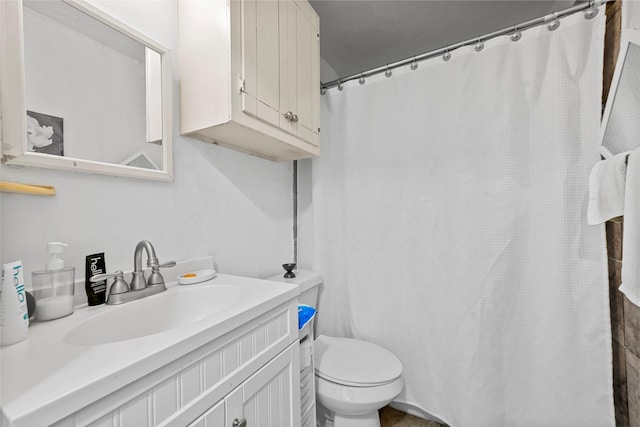 bathroom with toilet and vanity