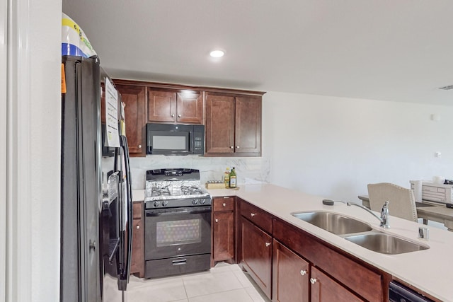 kitchen featuring black appliances, decorative backsplash, sink, kitchen peninsula, and light tile patterned floors