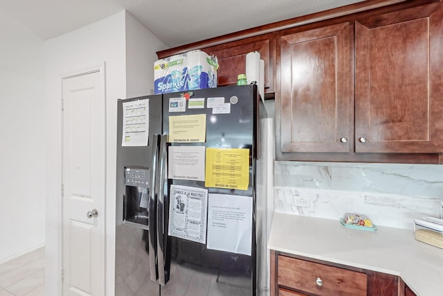 interior space with black fridge with ice dispenser