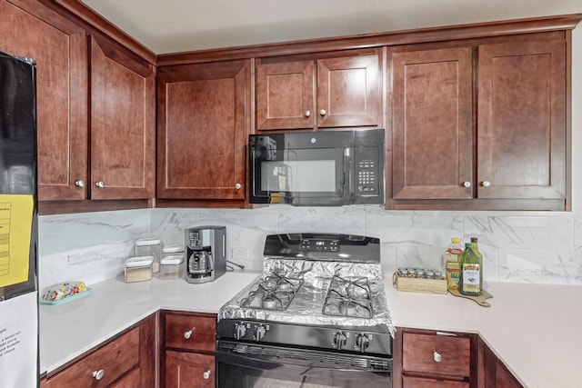 kitchen with black appliances and decorative backsplash