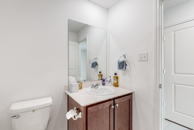 bathroom featuring tile patterned floors, toilet, and vanity