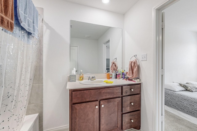 bathroom featuring shower / bath combo and vanity