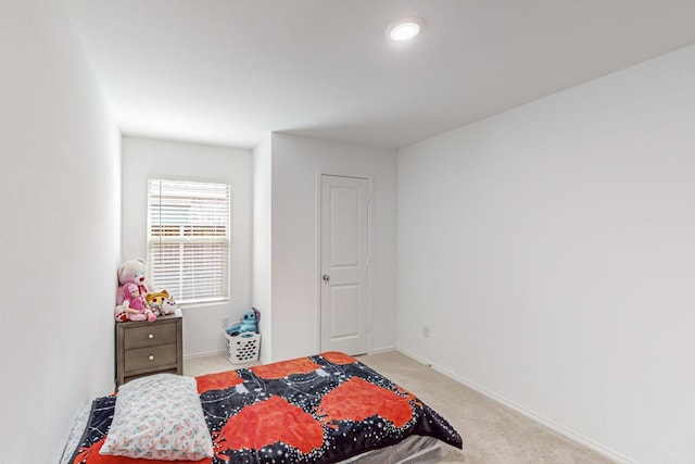 bedroom featuring light colored carpet