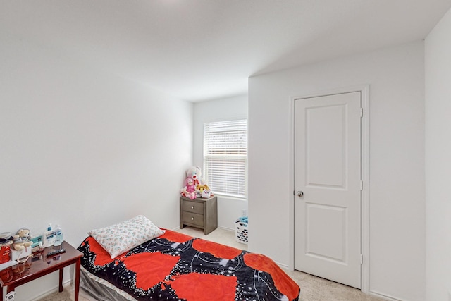 bedroom featuring light carpet