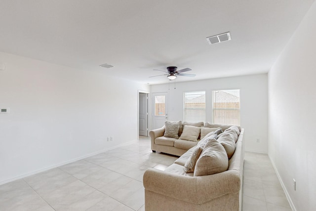 tiled living room with ceiling fan