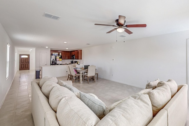 living room with light tile patterned flooring and ceiling fan