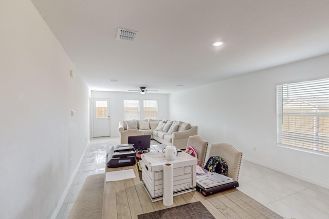 tiled living room featuring ceiling fan