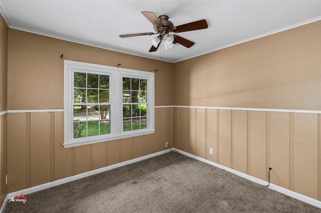 carpeted empty room with ceiling fan and ornamental molding