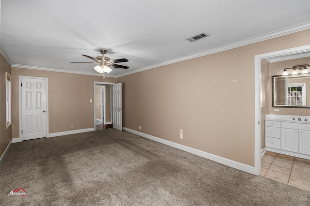 unfurnished bedroom with carpet flooring, ensuite bathroom, and ceiling fan