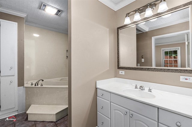 bathroom featuring a textured ceiling, tile patterned flooring, ornamental molding, vanity, and a bathing tub