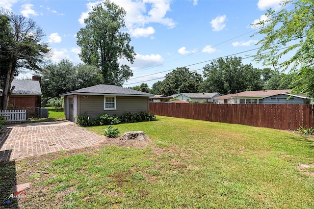 view of yard featuring an outdoor structure and a patio