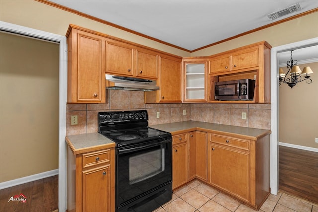 kitchen with black / electric stove, tasteful backsplash, light tile patterned flooring, ornamental molding, and a chandelier