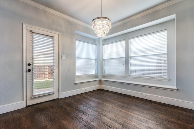 unfurnished dining area featuring crown molding, a chandelier, and dark wood-type flooring